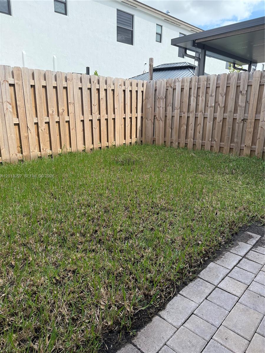 12955 Southwest 231st Terrace, Unit 12955 Miami, FL 33170 - Photo 26 of 26 a view of a backyard with wooden fence