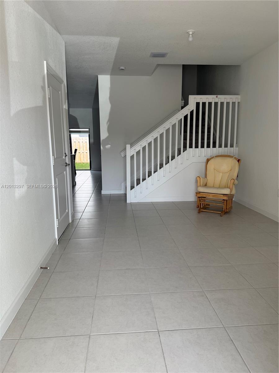 12955 Southwest 231st Terrace, Unit 12955 Miami, FL 33170 - Photo 5 of 26 a view of a hallway with staircase