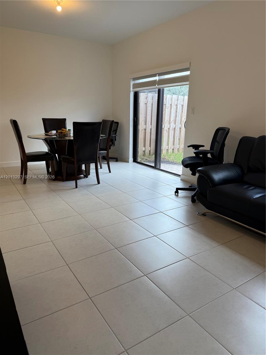 12955 Southwest 231st Terrace, Unit 12955 Miami, FL 33170 - Photo 7 of 26 a living room with furniture and floor to ceiling window