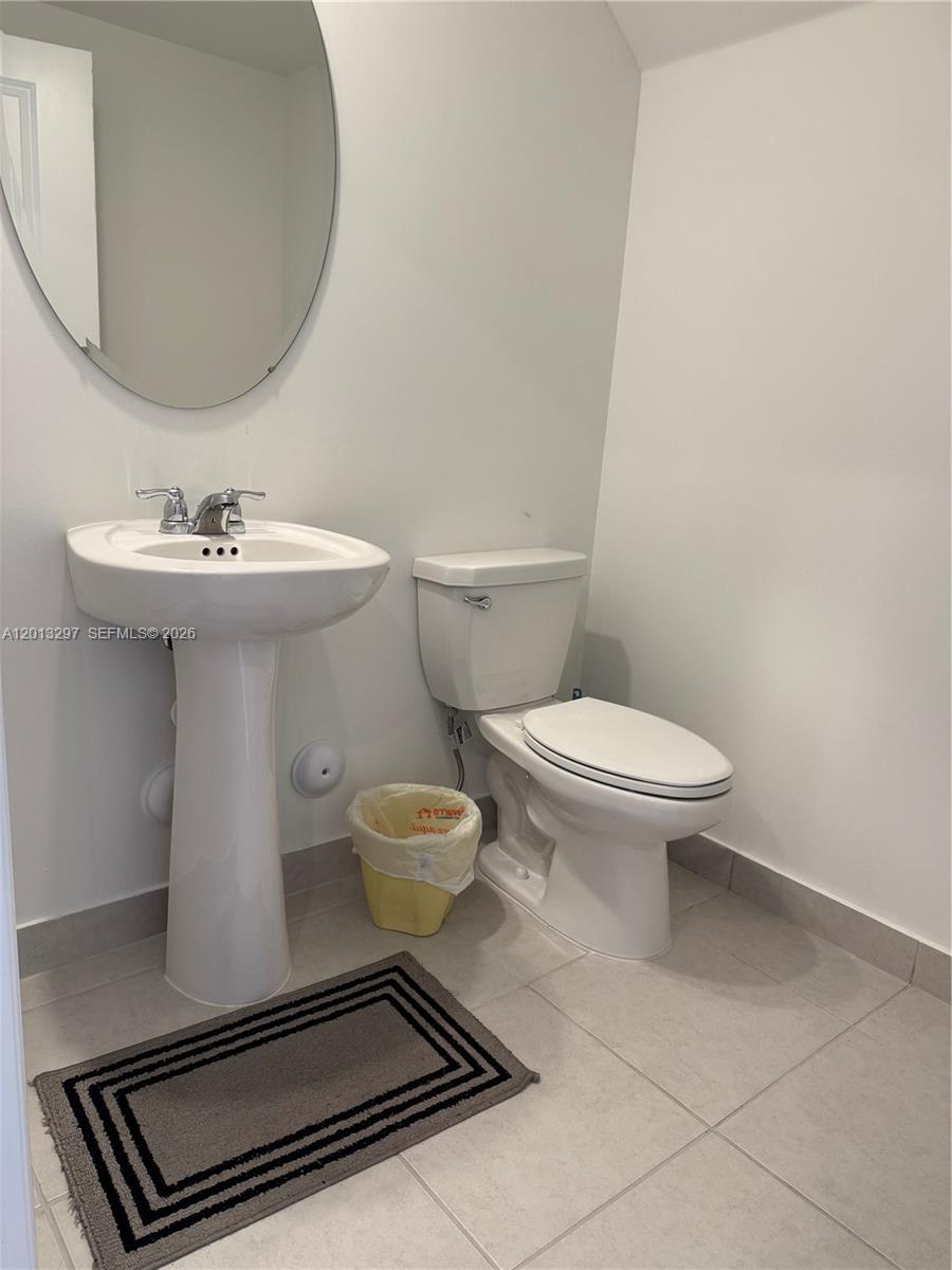 12955 Southwest 231st Terrace, Unit 12955 Miami, FL 33170 - Photo 10 of 26 a bathroom with a sink toilet and mirror