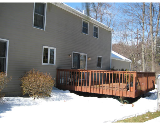 4 Wadsworth Road Ashland, MA 01721 - Photo 29 of 30 a view of a house with a wooden bench in a yard