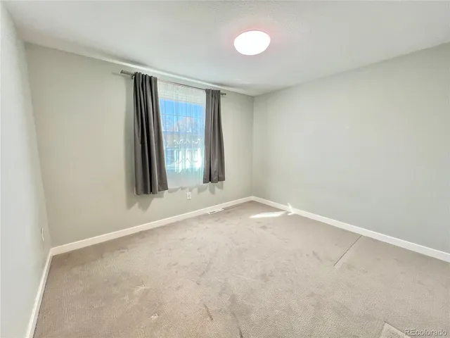 an empty room with a empty space and a window