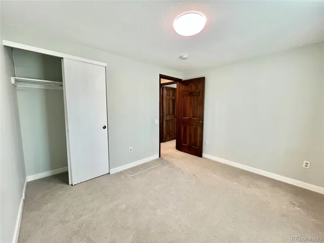 an empty room with closet area