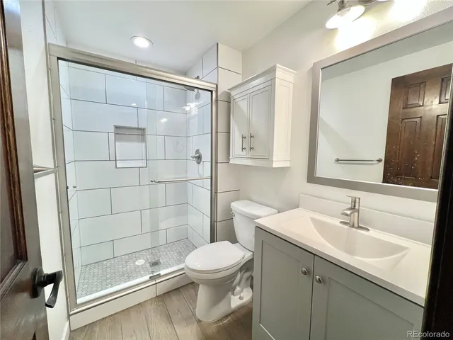 a bathroom with a sink toilet and shower