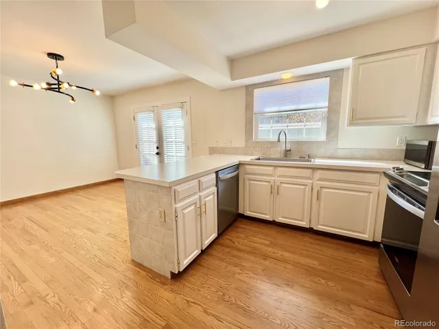 a kitchen with a sink stove and cabinets