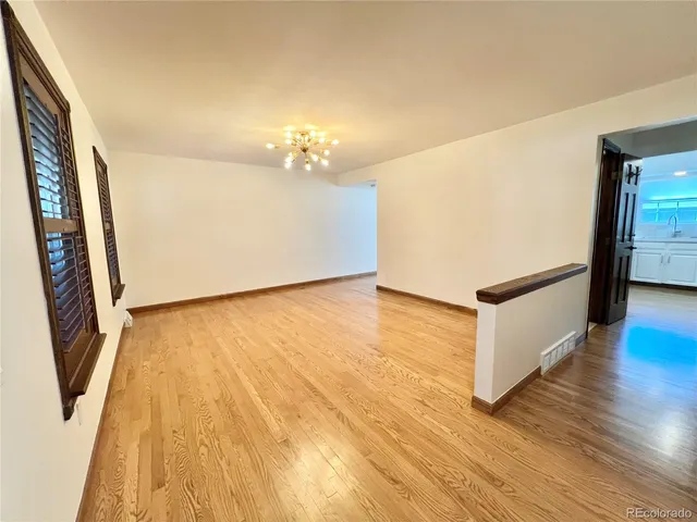 a view of a room with wooden floor