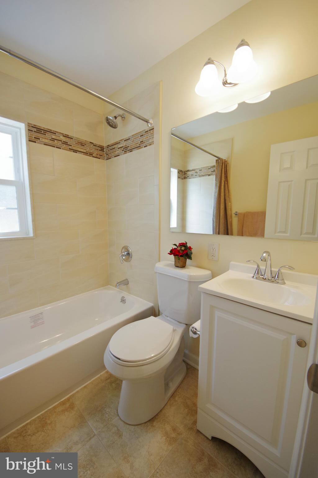 11505 Dewey Road Silver Spring, MD 20906 - Photo 14 of 29 a bathroom with a toilet sink vanity tub and shower