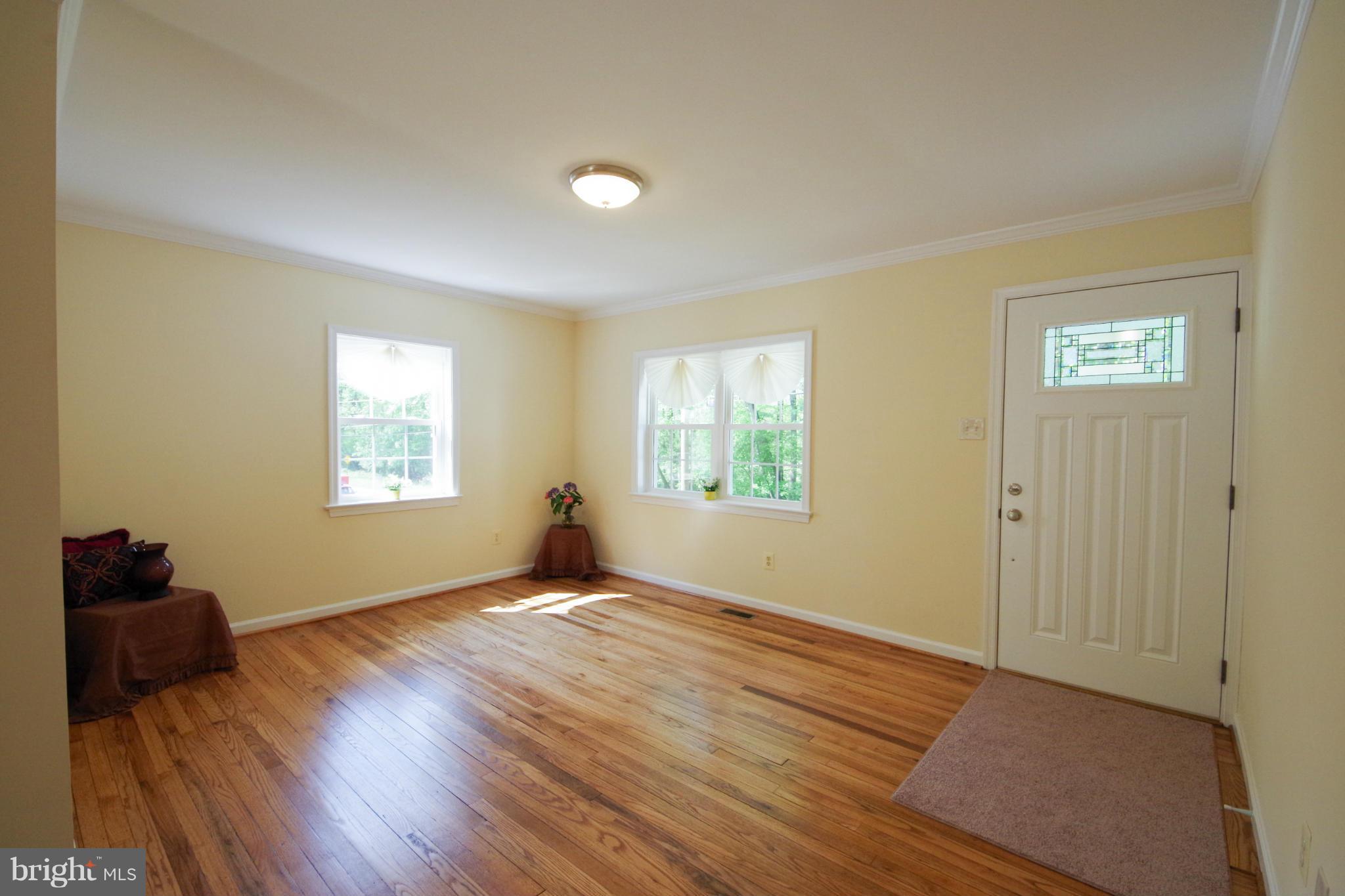 11505 Dewey Road Silver Spring, MD 20906 - Photo 8 of 29 a view of an empty room with wooden floor and a window