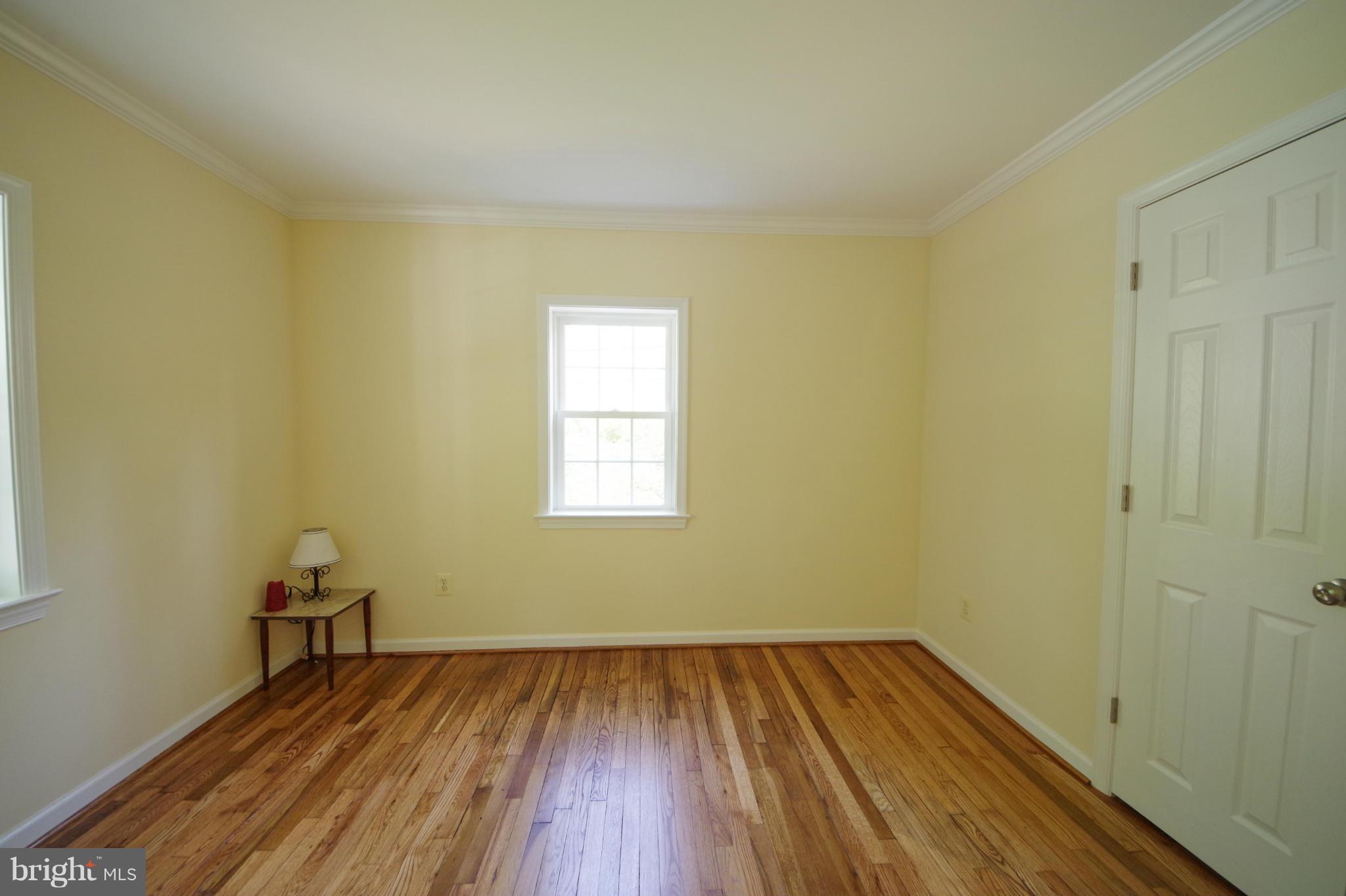11505 Dewey Road Silver Spring, MD 20906 - Photo 10 of 29 an empty room with wooden floor and windows