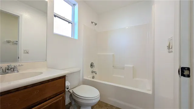 a bathroom with a sink toilet vanity and shower