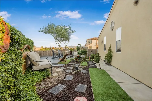 a view of a patio with table and chairs and potted plants