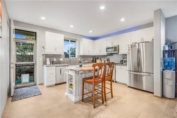 a kitchen with refrigerator cabinets and a table