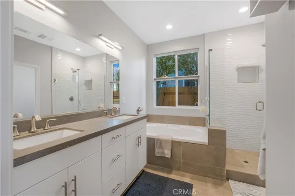 a bathroom with a granite countertop sink mirror and double