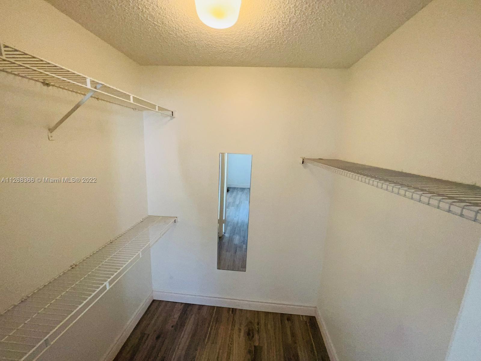 650 South Park Road, Unit 225 Hollywood, FL 33021 - Photo 17 of 26 a view of walk in closet with wooden floor
