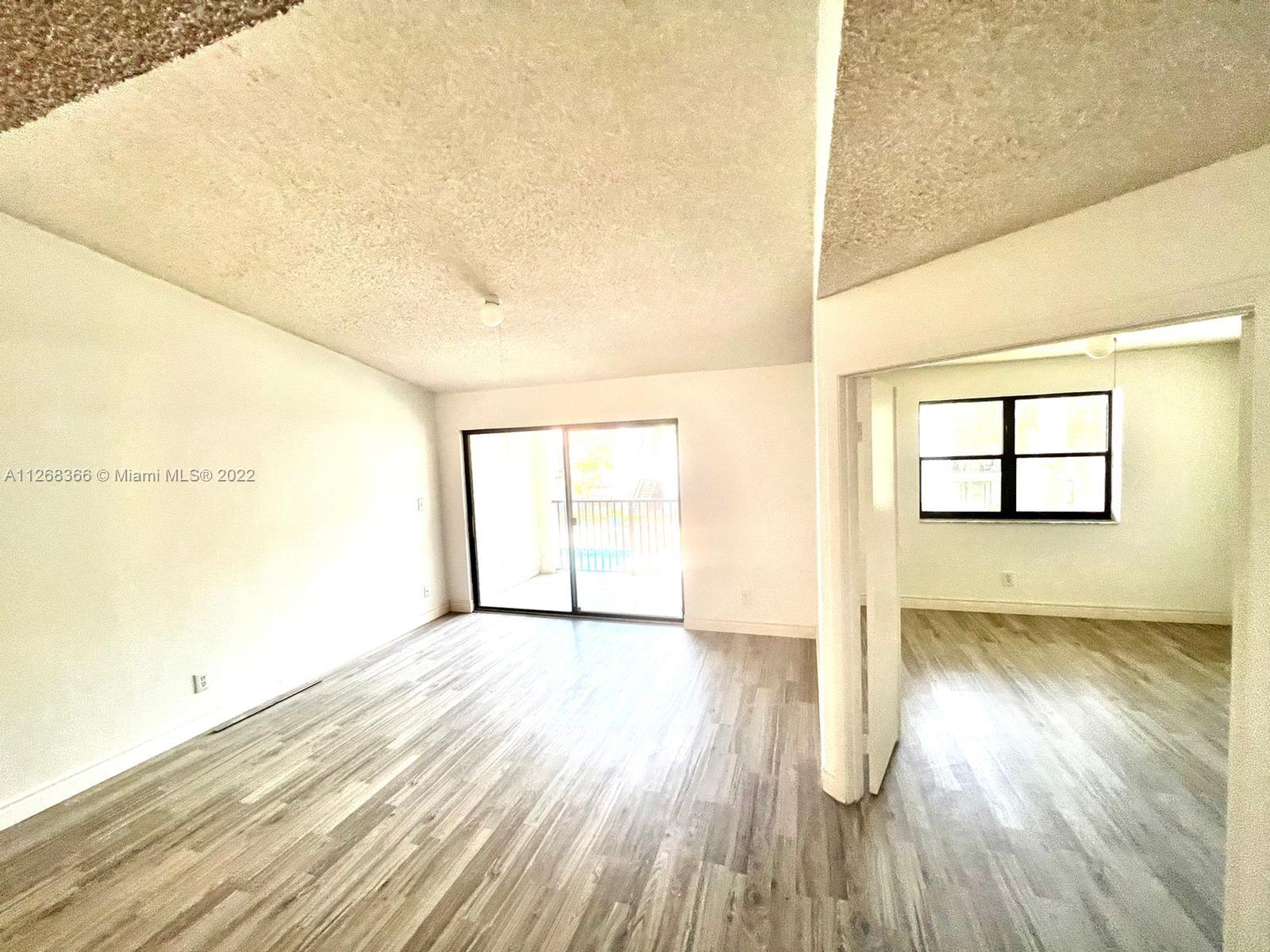 650 South Park Road, Unit 225 Hollywood, FL 33021 - Photo 10 of 26 an empty room with wooden floor and windows