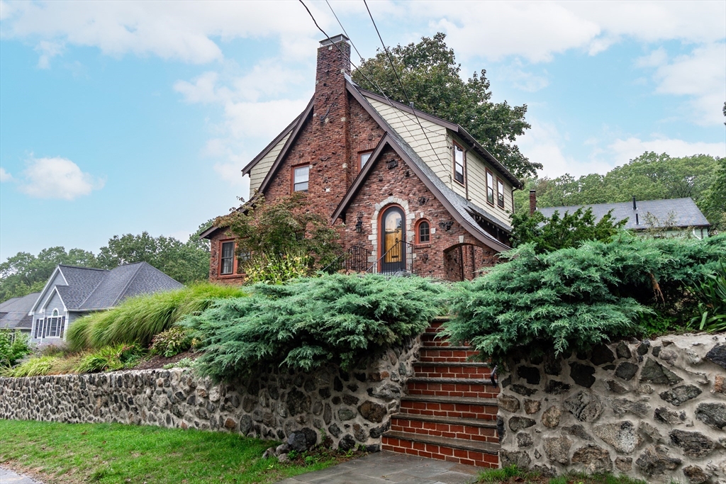 a view of a house with a yard and plants