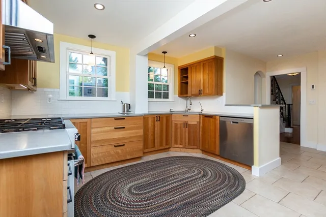 a kitchen with a stove a sink and a refrigerator