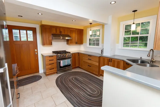 a kitchen with stainless steel appliances granite countertop a sink and cabinets