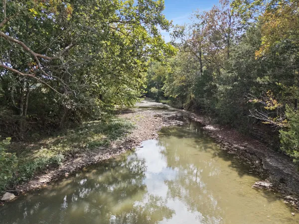 an aerial view of a house with yard swimming pool and mountain view