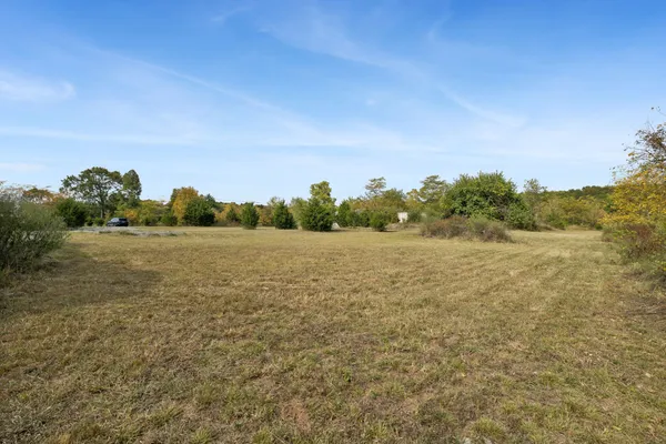 a view of a field with ocean view