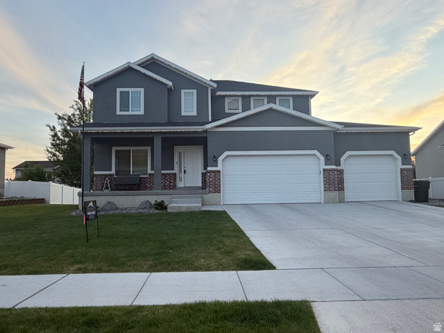 437 North 650 E Street Springville, UT 84663 - Photo 1 of 11 Two-story residence featuring a gray stucco exterior, white trim accents, and a covered front porch with brick column bases