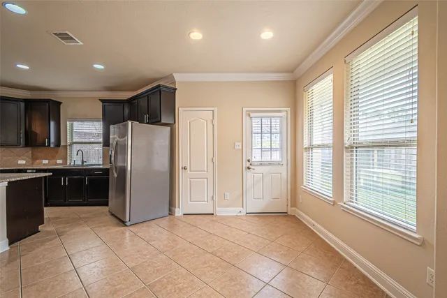 a kitchen with stainless steel appliances granite countertop a refrigerator and a sink