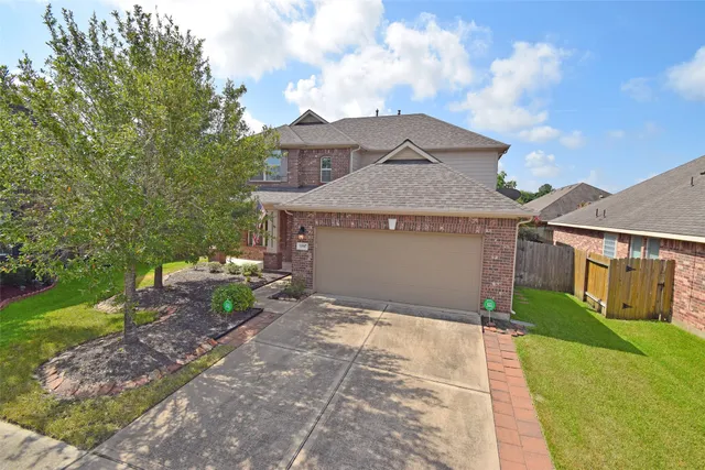 a front view of a house with a garden and yard