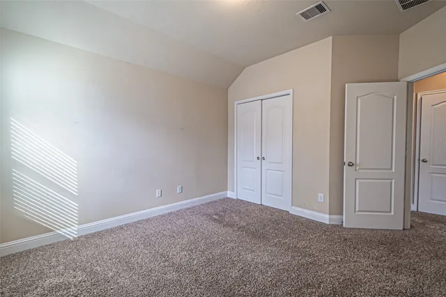 a view of a chair and table in backyard of the house