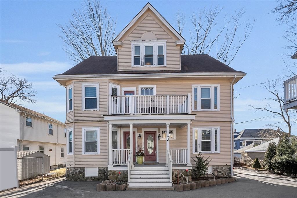 73 Orange Street, Unit 2 Waltham, MA 02453 - Photo 1 of 34 a front view of a house with a yard