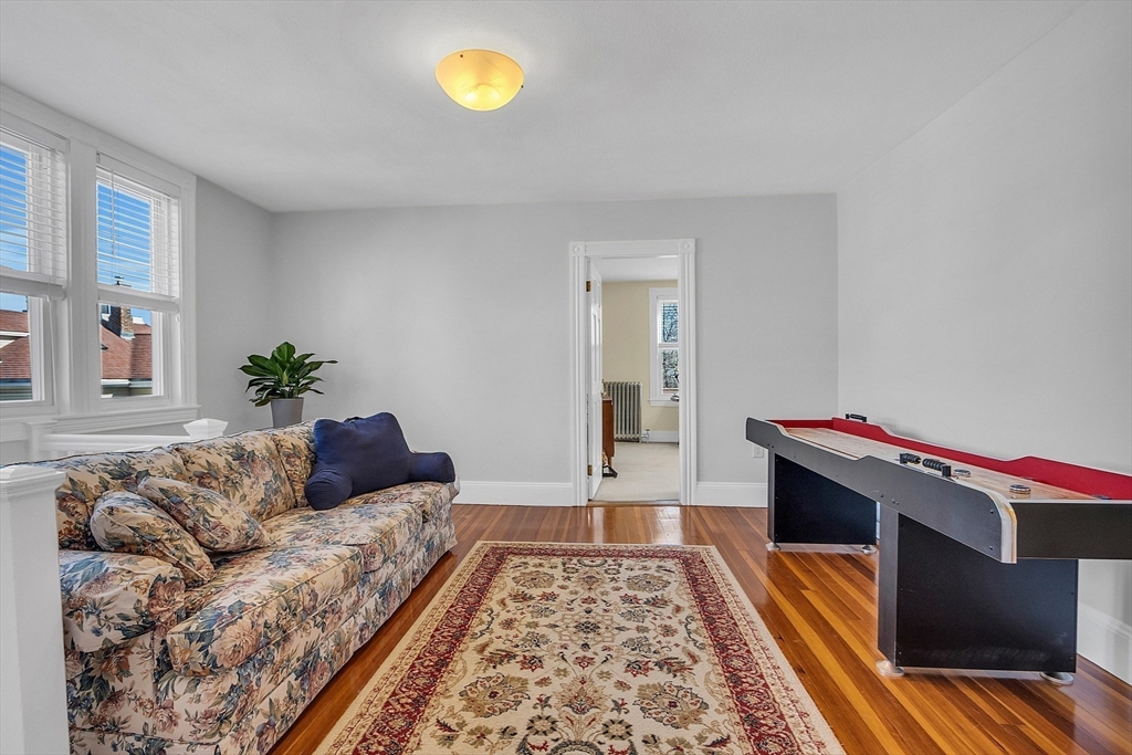 73 Orange Street, Unit 2 Waltham, MA 02453 - Photo 19 of 34 a living room with furniture and a rug