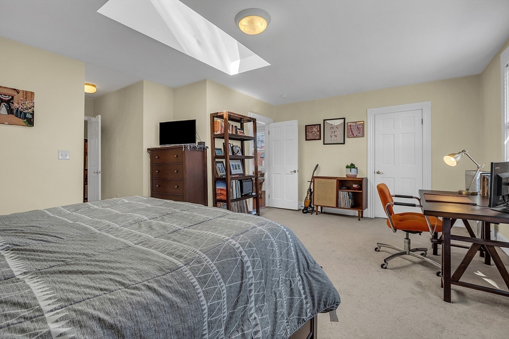 73 Orange Street, Unit 2 Waltham, MA 02453 - Photo 22 of 34 a bed room with a bed and a chair