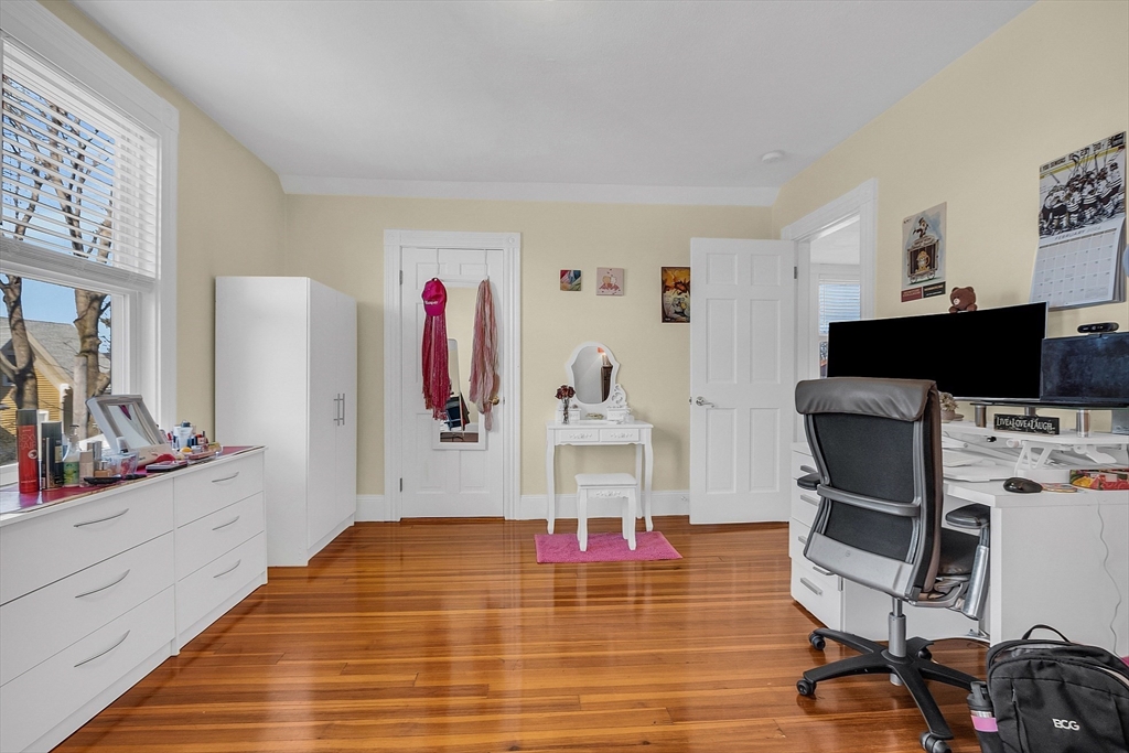 73 Orange Street, Unit 2 Waltham, MA 02453 - Photo 26 of 34 a view of a livingroom with workspace and a flat screen tv