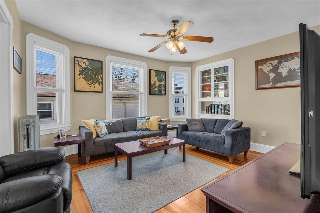 73 Orange Street, Unit 2 Waltham, MA 02453 - Photo 6 of 34 a living room with furniture and windows