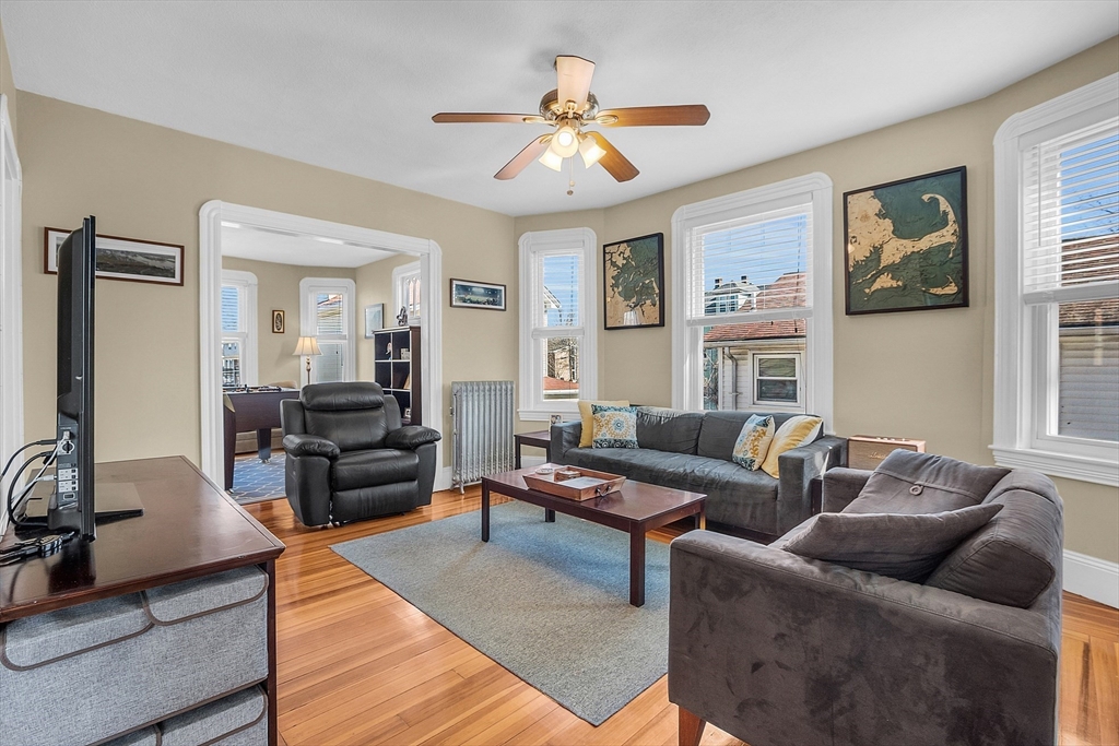 73 Orange Street, Unit 2 Waltham, MA 02453 - Photo 7 of 34 a living room with furniture and a large window