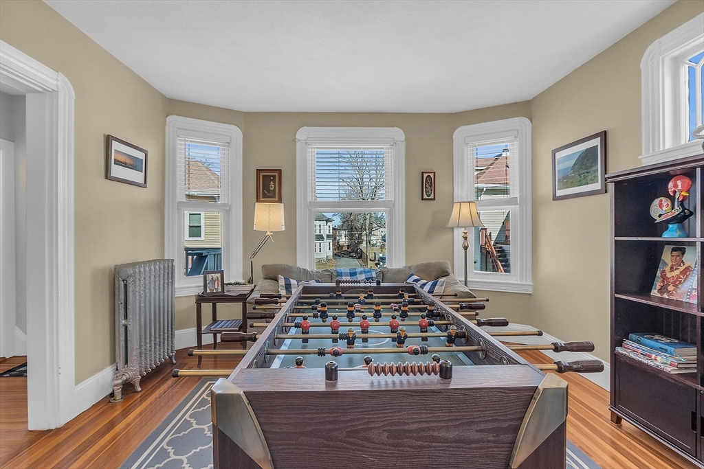 73 Orange Street, Unit 2 Waltham, MA 02453 - Photo 8 of 34 a living room with furniture rug and window