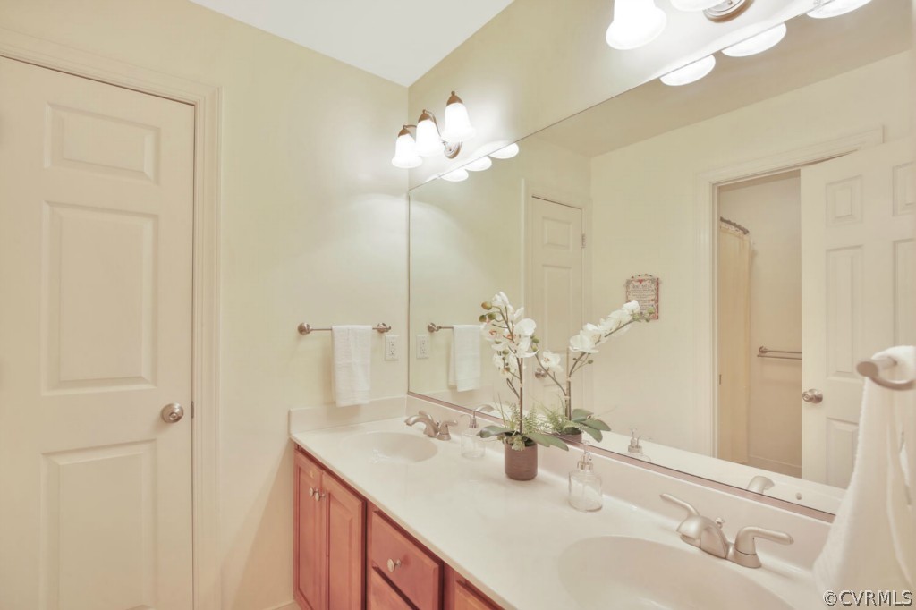 15311 River Road Chesterfield, VA 23838 - Photo 17 of 19 a bathroom with a sink vanity and a mirror