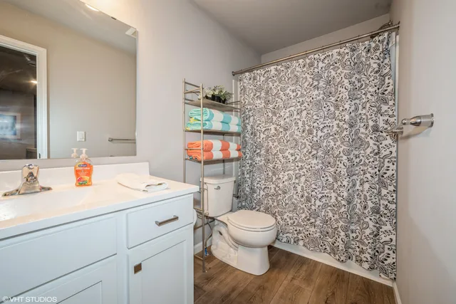 a bathroom with a sink toilet and a mirror