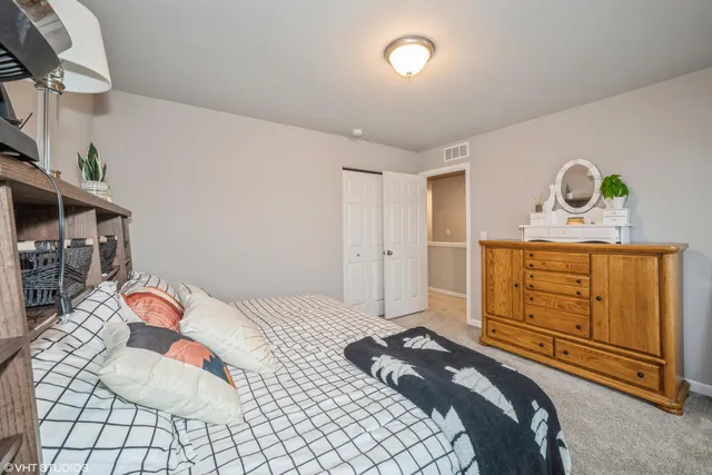 a bedroom with a bed and a dresser