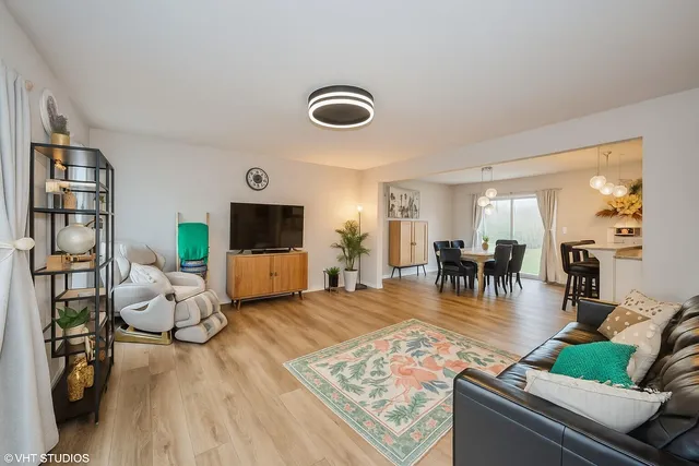 a living room with furniture and wooden floor
