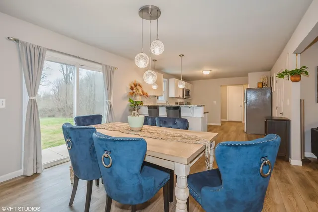 a view of a dining room with furniture window and wooden floor