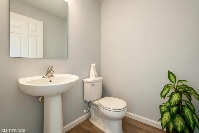 a bathroom with a sink a toilet and a mirror