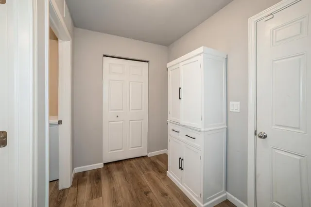 a view of walk in closet with wooden floor