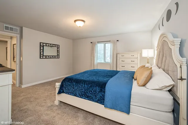 a bedroom with a bed and window