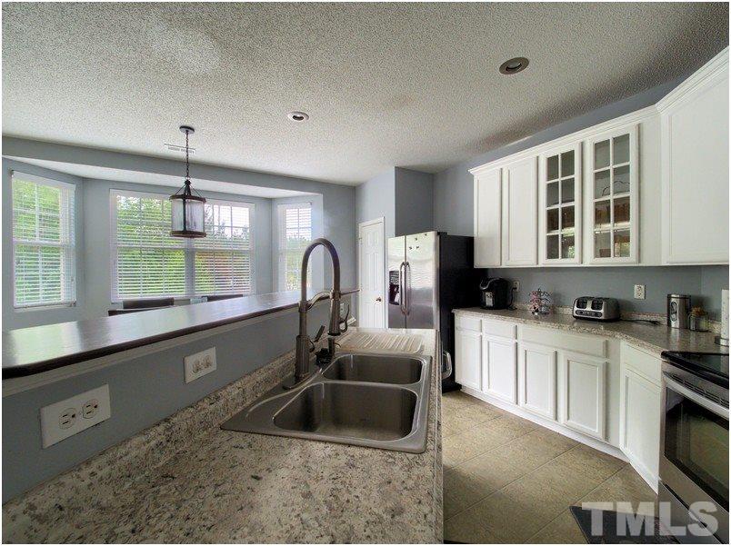 2647 Quarry Ridge Lane Raleigh, NC 27610 - Photo 8 of 18 a kitchen with granite countertop a sink and a stove top oven