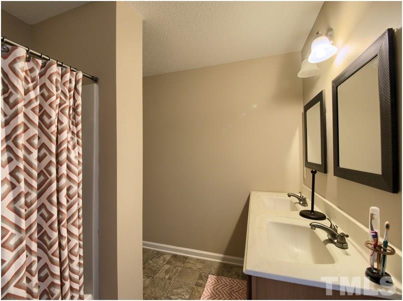 2647 Quarry Ridge Lane Raleigh, NC 27610 - Photo 10 of 18 a bathroom with a sink and a mirror
