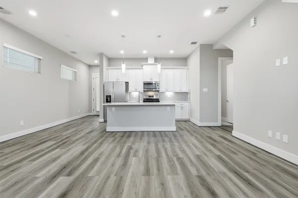 a view of kitchen with wooden floor and window