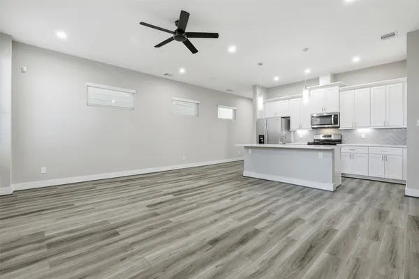 a kitchen with appliances a sink and cabinets