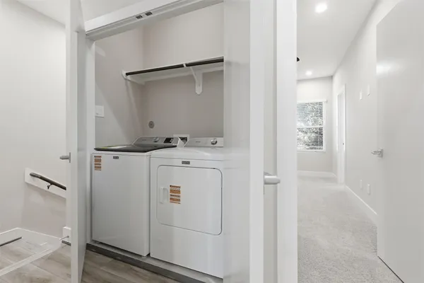 an entryway with wooden floor and cabinet