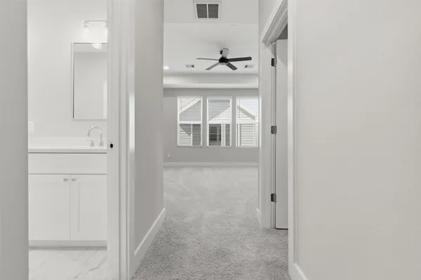 a spacious bathroom with a shower sink and mirror