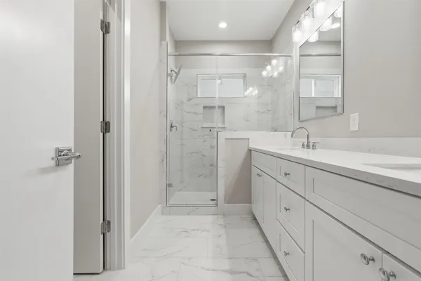 a bathroom with a sink vanity and mirror